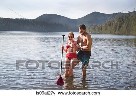 Stock Photo - "Young couple in lake, Lost Lake, Oregon, USA". Fotosearch