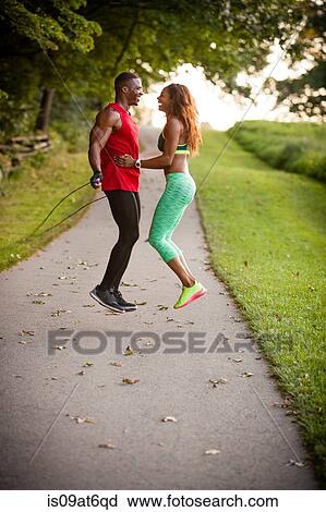 Young couple training on path skipping in unity View Large Photo Image Stock Image - Young couple training on path skipping in unity. Fotosearch