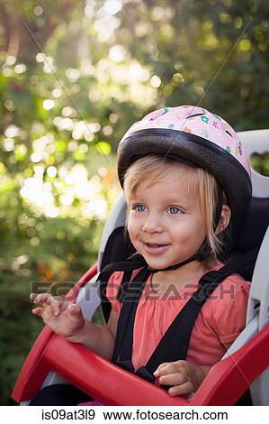 "Young girl sitting in child's bicycle seat, enjoying journey" View Large Photo Image Stock Photo - "Young girl sitting in child's bicycle seat, enjoying journey". Fotosearch
