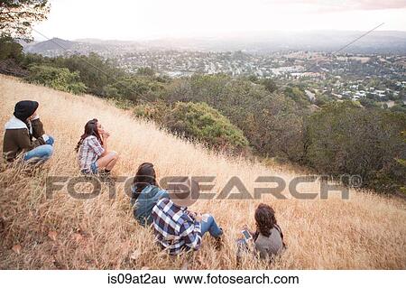 Young man and four adult sisters looking out from grassy hill View Large Photo Image Stock Photograph - Young man and four adult sisters looking out from grassy hill. Fotosearch