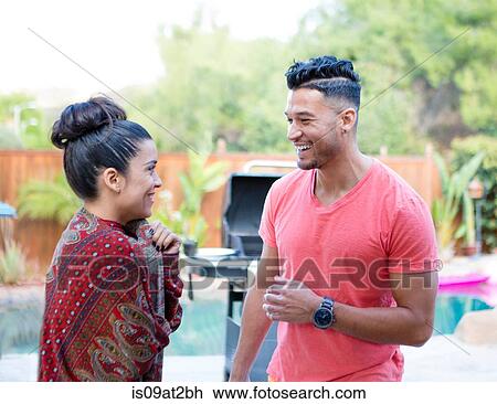 Young man and sister chatting at family barbecue View Large Photo Image Stock Image - Young man and sister chatting at family barbecue. Fotosearch