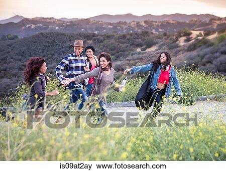 Young man running on rural road with four adult sisters View Large Photo Image Stock Photo - Young man running on rural road with four adult sisters. Fotosearch