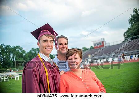 Young man standing with mother and father at graduation ceremony View Large Photo Image Stock Photography - Young man standing with mother and father at graduation ceremony. Fotosearch