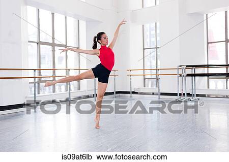 "Young woman in dance studio dancing, arms and leg raised" View Large Photo Image Stock Image - "Young woman in dance studio dancing, arms and leg raised". Fotosearch