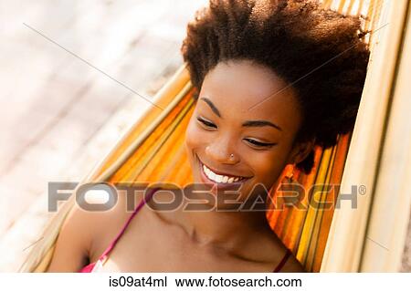 Young woman relaxing in hammock View Large Photo Image Stock Image - Young woman relaxing in hammock. Fotosearch