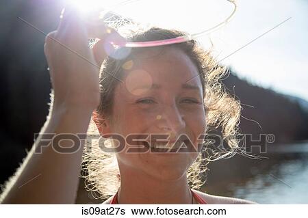Young woman smiling in sunlight View Large Photo Image Stock Photograph - Young woman smiling in sunlight. Fotosearch