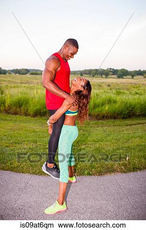 Young woman training by lifting up boyfriend View Large Photo Image Picture - Young woman training by lifting up boyfriend. Fotosearch