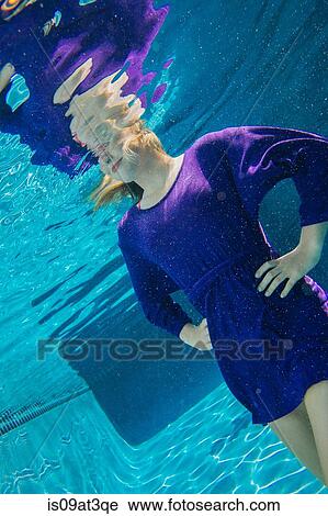 Stock Image - "Young woman underwater, hands on hips". Fotosearch