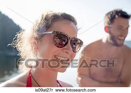 "Young woman wearing sunglasses, smiling" View Large Photo Image Stock Photography - "Young woman wearing sunglasses, smiling". Fotosearch