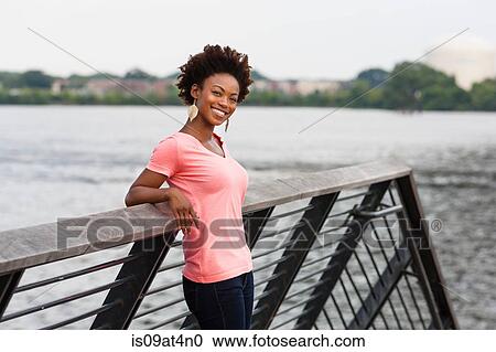 Stock Image - Young woman with afro hair. Fotosearch