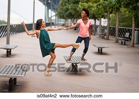 Young women dancing and balancing on one leg View Large Photo Image Stock Image - Young women dancing and balancing on one leg. Fotosearch