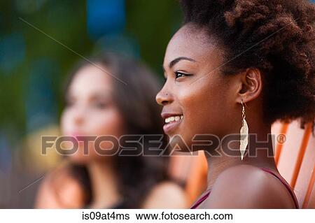 Stock Photograph - Young women relaxing on deck chair. Fotosearch