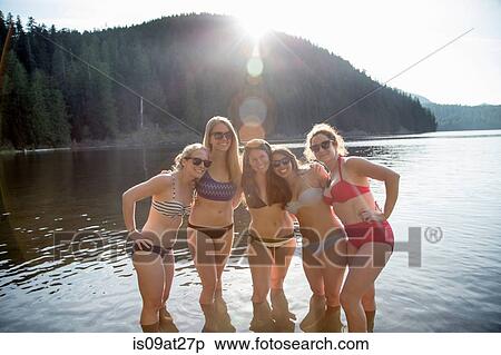 Stock Photography - "Young women smiling wearing bikinis, Lost Lake, Oregon, USA". Fotosearch