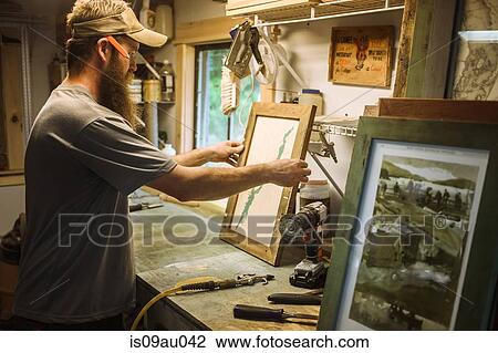 Artist working in workshop, framing artwork View Large Photo Image Stock Image - Artist working in workshop, framing artwork. Fotosearch