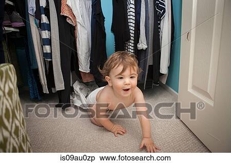 Baby boy crawling, emerging from wardrobe View Large Photo Image Stock Photography - Baby boy crawling, emerging from wardrobe. Fotosearch