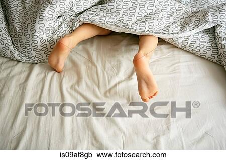 Bare feet of boy under duvet in bed View Large Photo Image Stock Image - Bare feet of boy under duvet in bed. Fotosearch