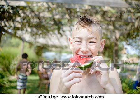 Boy enjoying watermelon at tomato eating festival View Large Photo Image Stock Image - Boy enjoying watermelon at tomato eating festival. Fotosearch