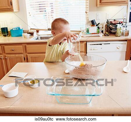Boy preparing batter in mixing bowl View Large Photo Image Stock Image - Boy preparing batter in mixing bowl. Fotosearch