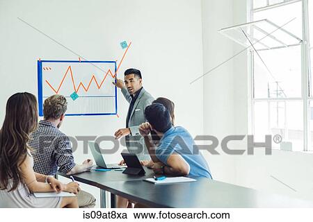 Stock Image - Business people in brainstorming meeting. Fotosearch