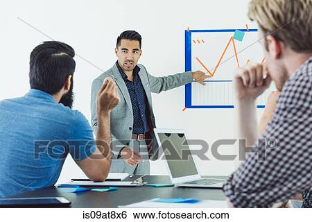 Stock Photograph - Business people in brainstorming meeting. Fotosearch