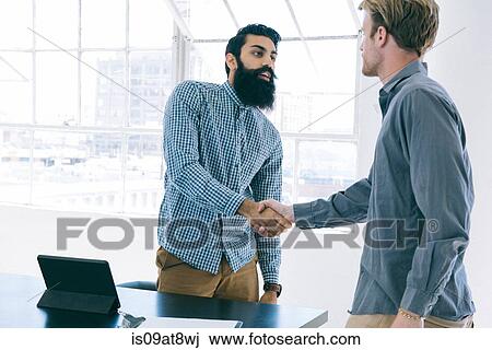 Business people shaking hands at meeting View Large Photo Image Stock Image - Business people shaking hands at meeting. Fotosearch