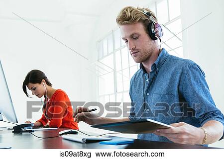 Stock Image - Business people working in office. Fotosearch
