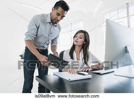 Picture - Business people working on computer at office. Fotosearch