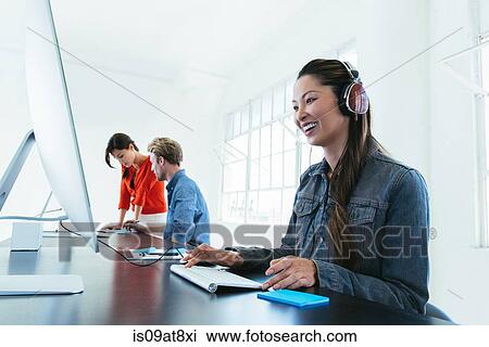 Business people working on computer by office window View Large Photo Image Stock Image - Business people working on computer by office window. Fotosearch