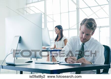 Business people working on computer by office window View Large Photo Image Stock Image - Business people working on computer by office window. Fotosearch