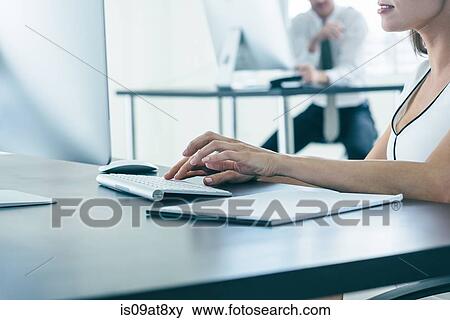 Business people working on computer by office window View Large Photo Image Stock Photo - Business people working on computer by office window. Fotosearch
