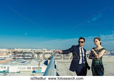 Businessman and businesswoman looking at view on roof terrace, Los Angeles, California, USA View Large Photo Image Stock Photography - Businessman and businesswoman looking at view on roof terrace, Los Angeles, California, USA. Fotosearch