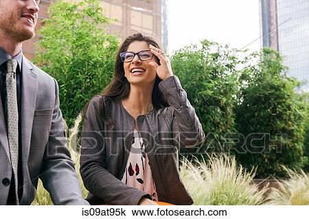 Businessman and woman talking in city View Large Photo Image Stock Image - Businessman and woman talking in city. Fotosearch