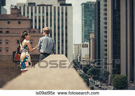 Businessman and woman talking on rooftop, Los Angeles, USA View Large Photo Image Stock Photo - Businessman and woman talking on rooftop, Los Angeles, USA. Fotosearch