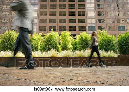 Businessman and woman walking in opposite directions View Large Photo Image Stock Photo - Businessman and woman walking in opposite directions. Fotosearch