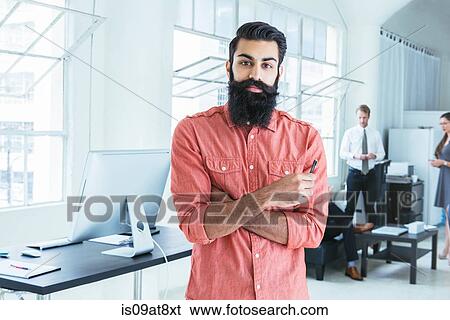 Stock Photograph - Businessman, colleagues working in background. Fotosearch