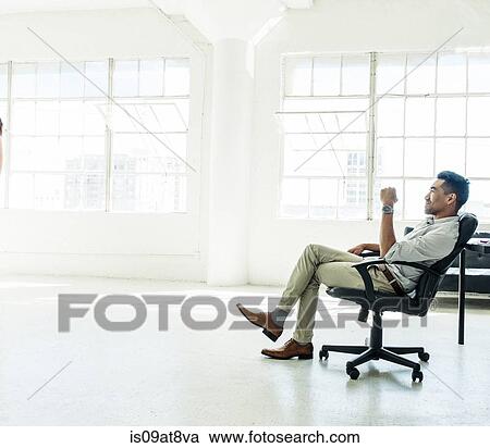 Businessman contemplating by office window View Large Photo Image Stock Image - Businessman contemplating by office window. Fotosearch