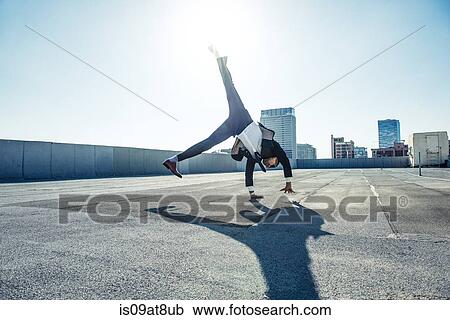Businessman doing handstand on roof terrace, Los Angeles, California, USA View Large Photo Image Stock Image - Businessman doing handstand on roof terrace, Los Angeles, California, USA. Fotosearch