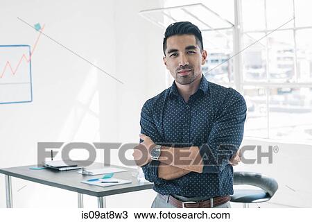 Businessman with arms crossed by office window View Large Photo Image Stock Image - Businessman with arms crossed by office window. Fotosearch