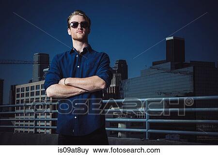 Businessman with arms crossed on roof terrace, Los Angeles, California, USA View Large Photo Image Stock Photo - Businessman with arms crossed on roof terrace, Los Angeles, California, USA. Fotosearch