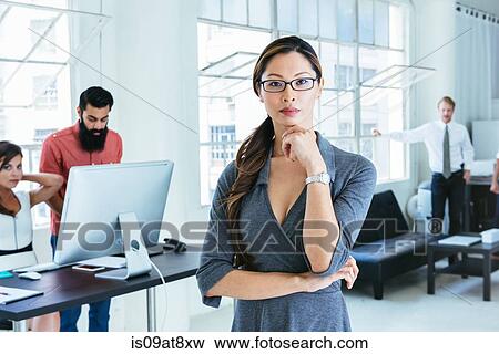 Businesswoman, colleagues working on computer by office window View Large Photo Image Stock Photo - Businesswoman, colleagues working on computer by office window. Fotosearch