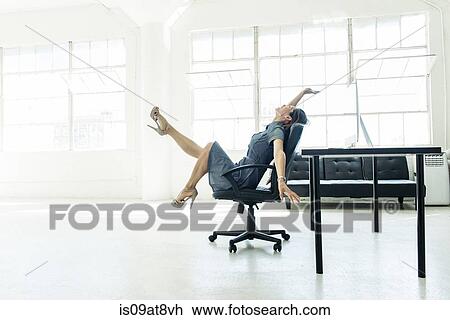 Businesswoman excited on chair by office window View Large Photo Image Stock Image - Businesswoman excited on chair by office window. Fotosearch