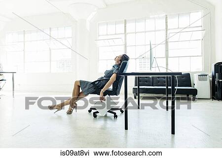 Businesswoman exhausted on chair by office window View Large Photo Image Stock Image - Businesswoman exhausted on chair by office window. Fotosearch