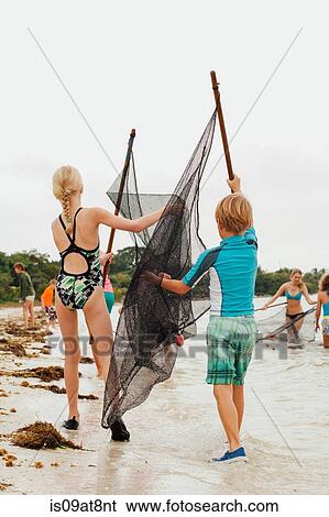 Children learning how to use traditional fishing net, Sanibel Island, Pine Island Sound, Florida, USA View Large Photo Image Stock Photograph - Children learning how to use traditional fishing net, Sanibel Island, Pine Island Sound, Florida, USA. Fotosearch