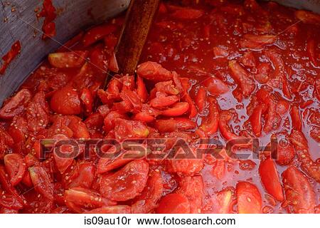 Stock Photography - Chopped tomatoes cooking in pan. Fotosearch