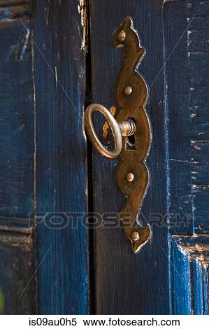 Close up view of key in lock on blue wooden door View Large Photo Image Stock Photography - Close up view of key in lock on blue wooden door. Fotosearch