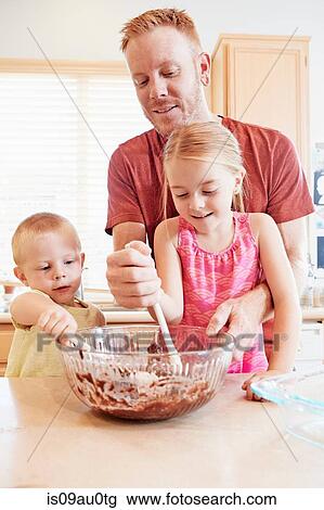 Family melting chocolate in mixing bowl View Large Photo Image Stock Image - Family melting chocolate in mixing bowl. Fotosearch