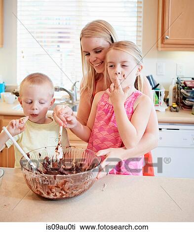 Family melting chocolate in mixing bowl View Large Photo Image Stock Image - Family melting chocolate in mixing bowl. Fotosearch