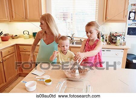 Family preparing batter in mixing bowl View Large Photo Image Stock Image - Family preparing batter in mixing bowl. Fotosearch