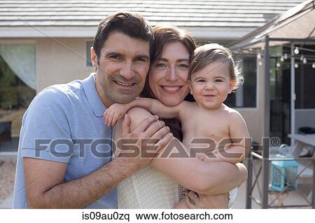 Family with baby boy hugging and smiling looking at camera smiling View Large Photo Image Stock Photography - Family with baby boy hugging and smiling looking at camera smiling. Fotosearch