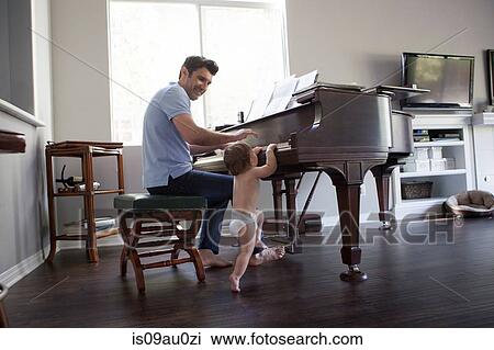 Father and baby boy playing on piano View Large Photo Image Stock Image - Father and baby boy playing on piano. Fotosearch